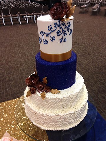 4 tier ruffled buttercream with bronze and royal blue